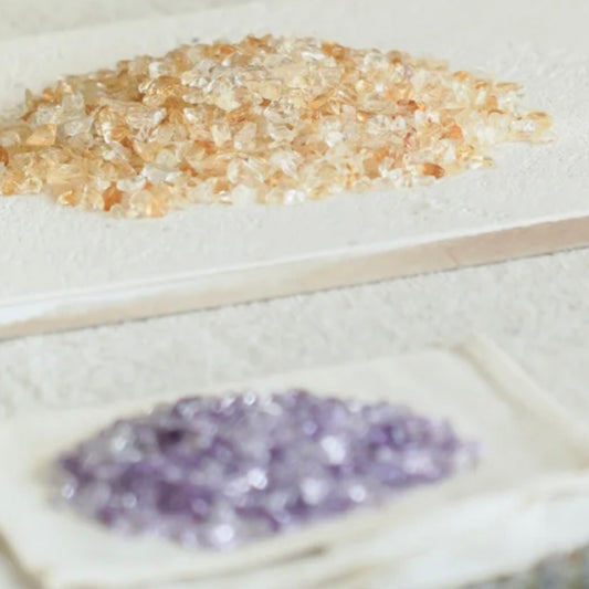 High-grade Amethyst crystal chips in a round glass box, designed for spiritual protection and anxiety relief.