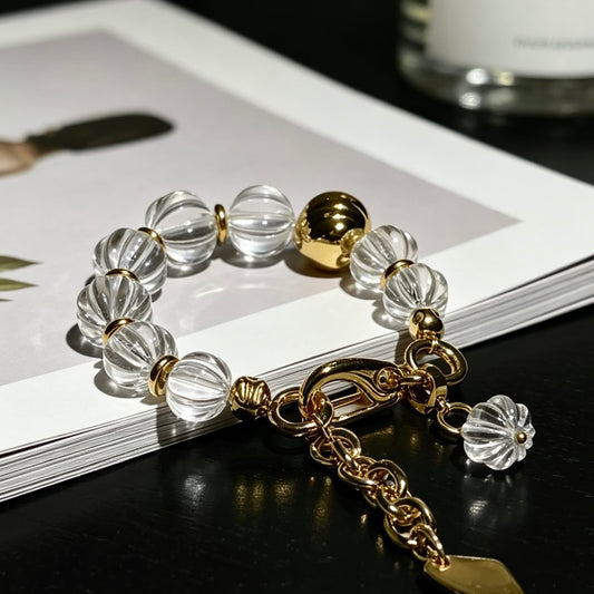 Close-up of the hand-carved fluted texture on clear quartz beads, showcasing premium light refraction.