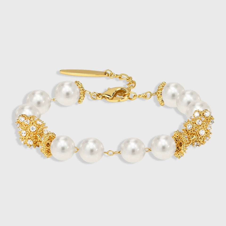 Individual shot of the shell pearl bracelet featuring designer gold-tone hardware.