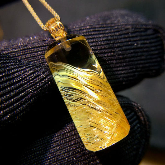 Macro detail showing the "natural fingerprint" of the titanium rutilated quartz fibers.