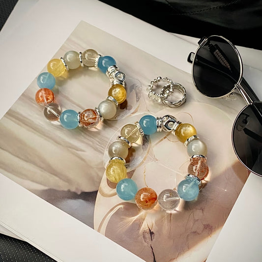 Close-up of 15mm orange flower agate, brushed yellow fluorite and Brazilian clear quartz beads on candy-colored crystal bracelet, fade-proof finish