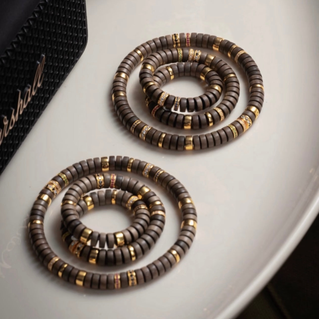 Close-up of authentic ebony sandalwood grain and handcrafted flat round bead details.