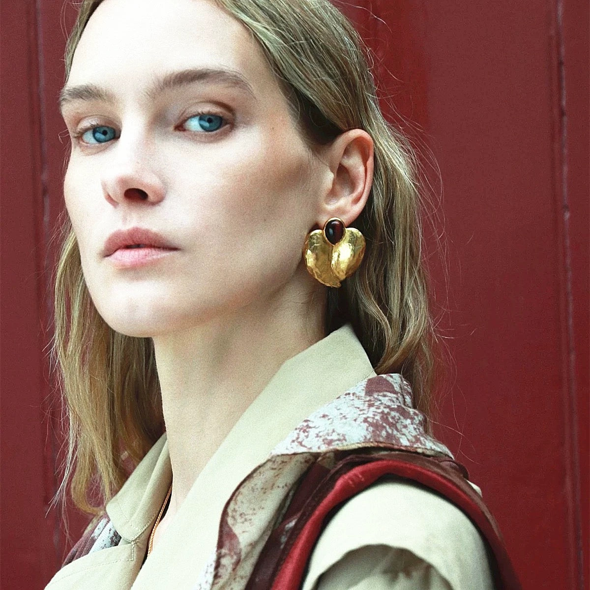 Back view of the gilded petal earrings showing the secure stud fastening and premium alloy finish.