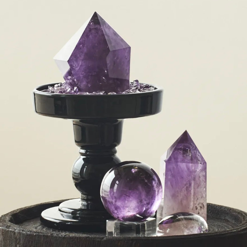 Amethyst Energy Grid including natural points, sphere, and a black base tray with amethyst chips on a dark wood surface.