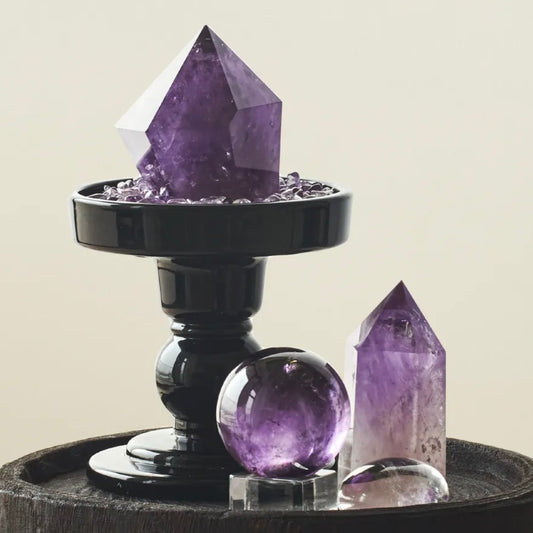 Amethyst Energy Grid including natural points, sphere, and a black base tray with amethyst chips on a dark wood surface.