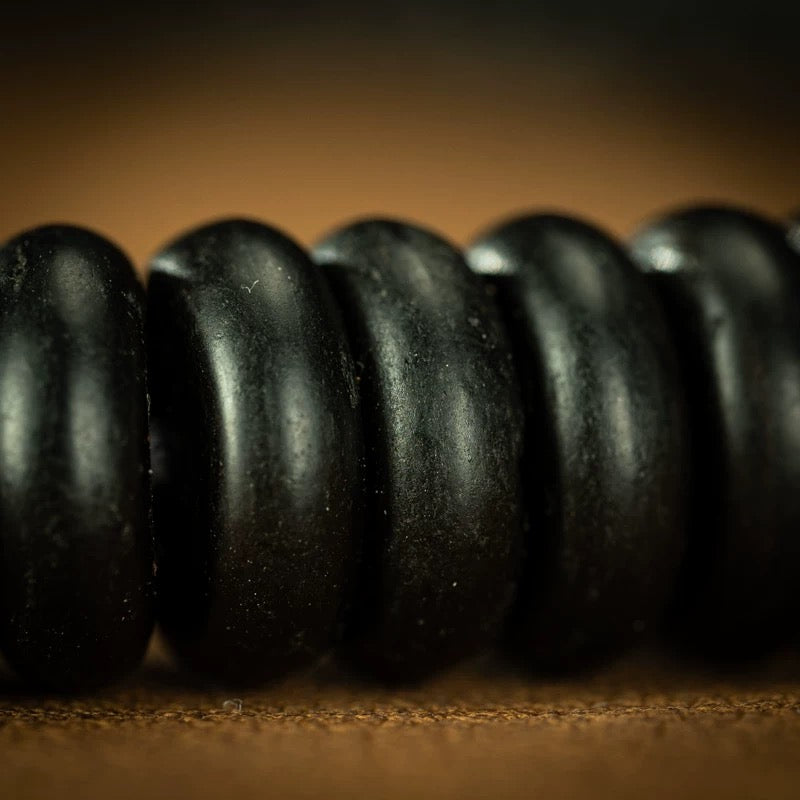 Detailed shot of the weathered antique accent bead on the 300-year-old strand.
