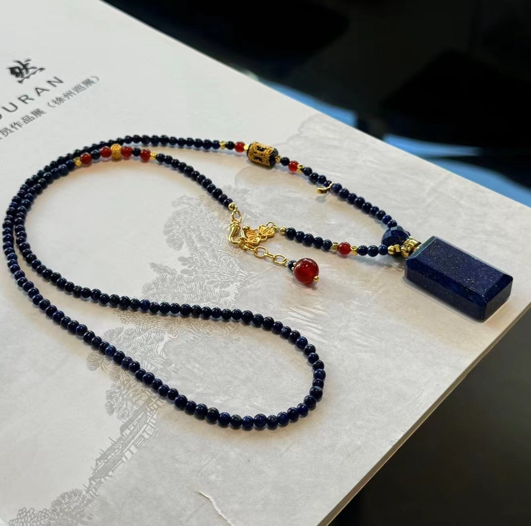 The lapis lazuli aromatherapy vessel displayed as a vintage-inspired art piece.