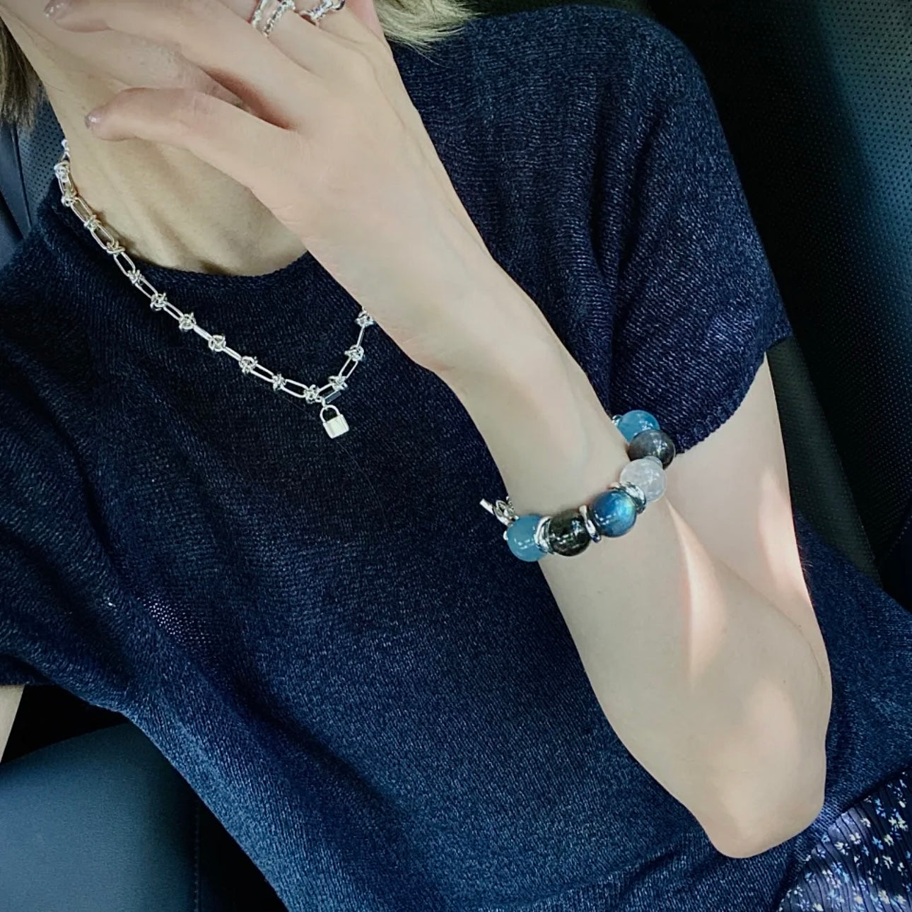 Hand model wearing an Aquamarine and Moonstone bracelet styled for everyday fashion, minimalist wardrobes, and contemporary crystal jewelry collections.