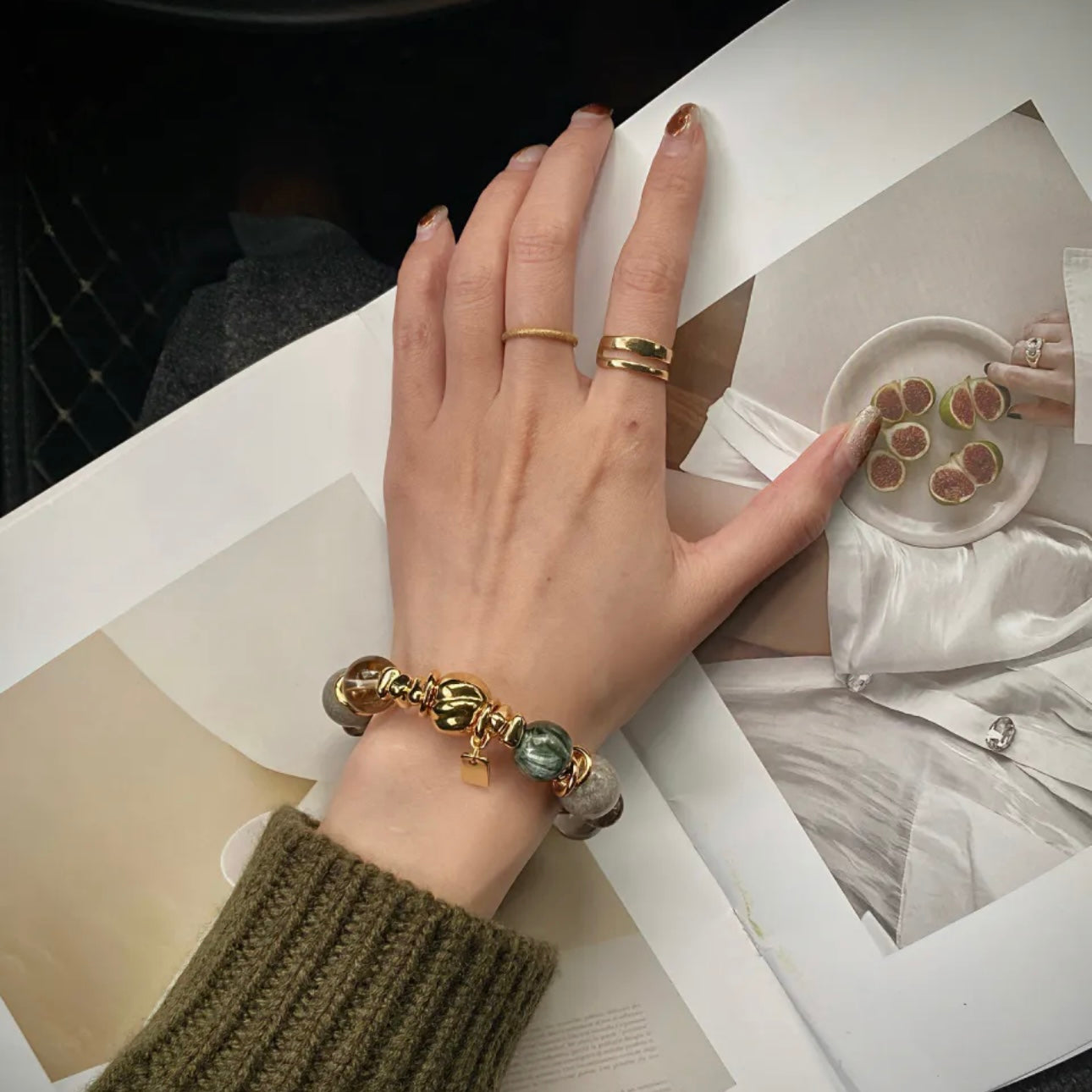  Model wearing a green dragon and phantom quartz bracelet with gold industrial links.