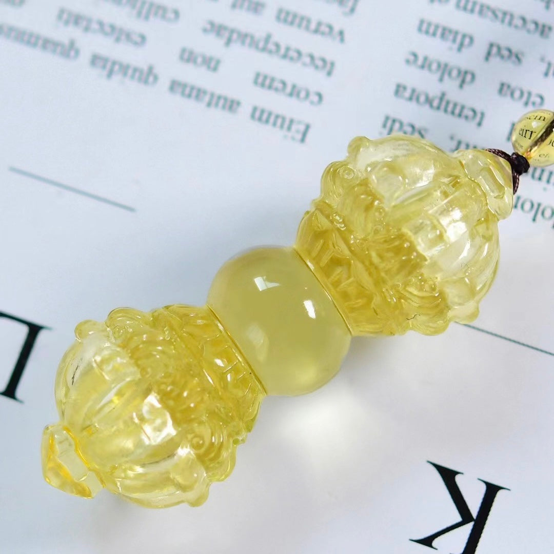 Close-up of Nine-Pronged Vajra Pendant highlighting precise carving lines and natural Brazilian yellow crystal texture