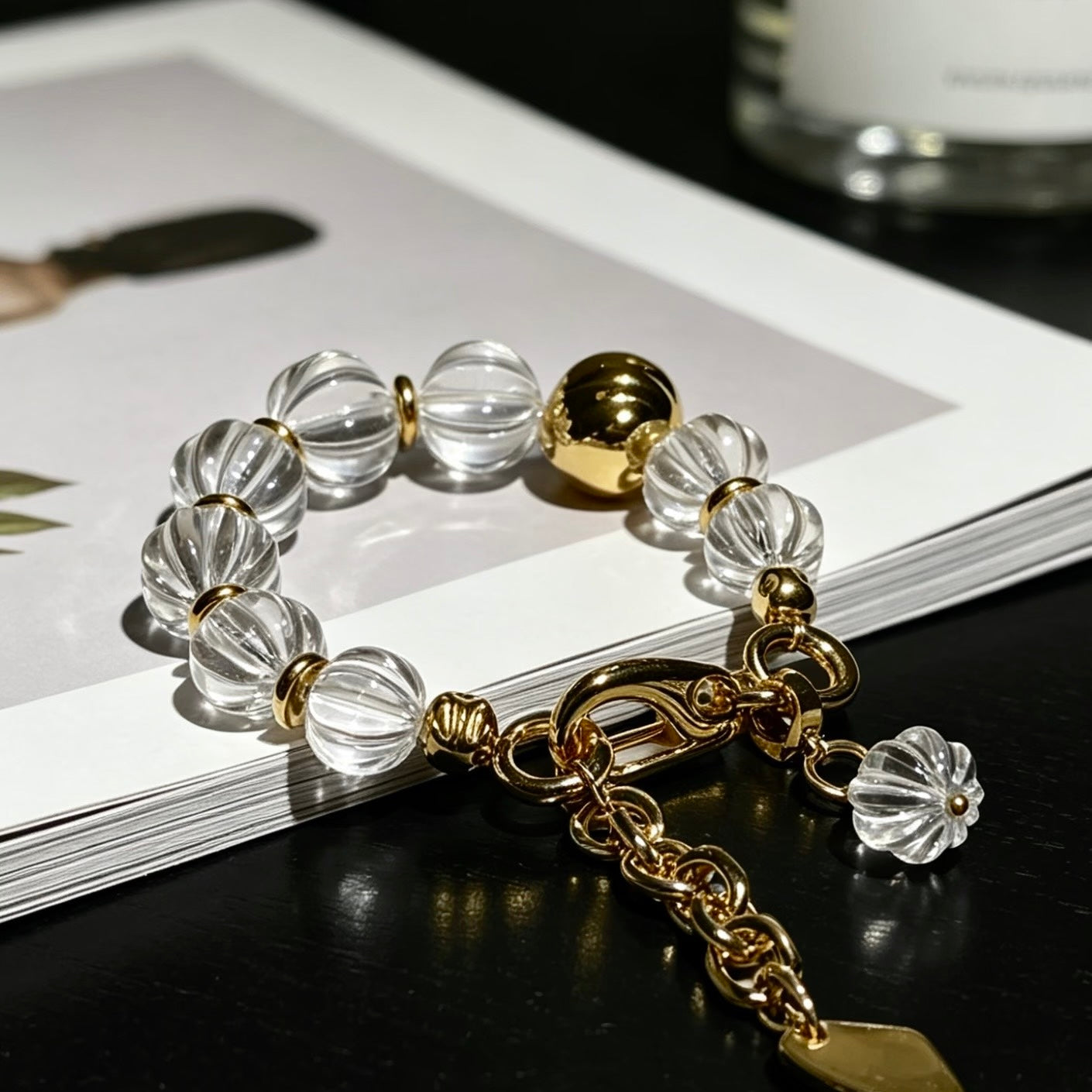 Close-up of the hand-carved fluted texture on clear quartz beads, showcasing premium light refraction.