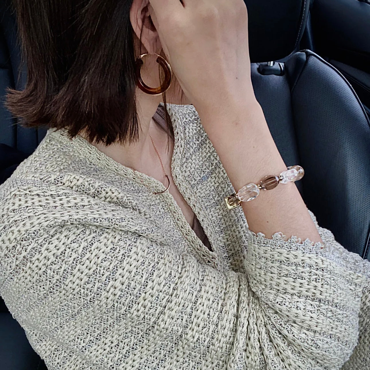 Natural crystal bracelet featuring Smoky Quartz and Clear Quartz paired with a neutral wardrobe for effortless everyday styling.