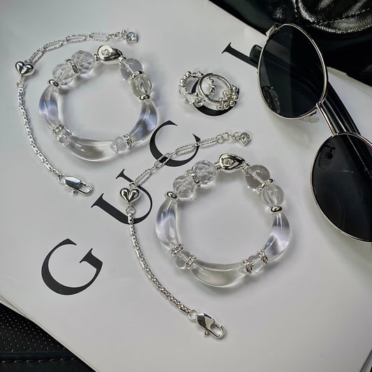 Clear quartz half-bangle bracelet with pineapple, pumpkin, UFO and round cut beads, flat lay on neutral surface — double-A grade natural crystal with 999 silver-plated titanium hardware