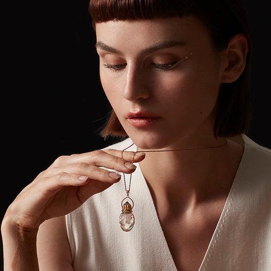 Model wearing the Clear Quartz perfume bottle necklace, showcasing the elegant 40mm pendant and 925 silver chain.