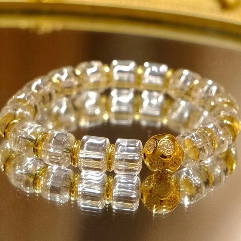Close-up of 11mm wheel beads on a model's wrist, highlighting the high-clarity quartz.