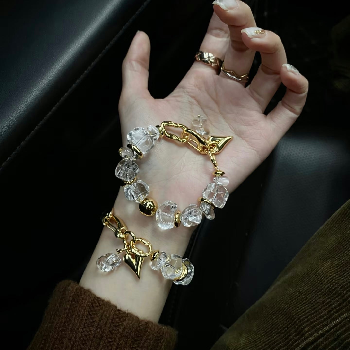 Detailed view of the 15mm raw rock crystal beads and 24K gold plating against skin.