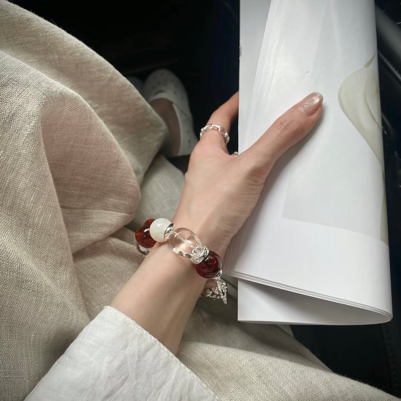 Blood amber bracelet detail – natural stone texture and pearl accent, Crimson Solitude