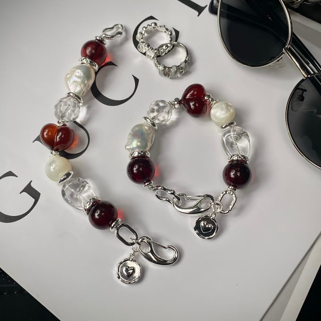 Close-up of blood amber beads with pearl and clear crystal bracelet – Crimson Solitude