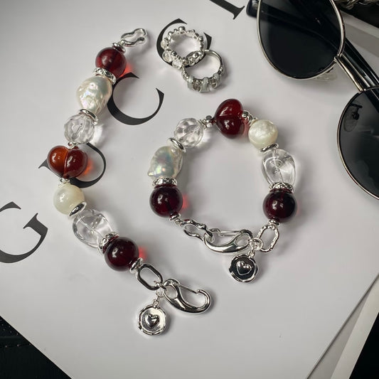Close-up of blood amber beads with pearl and clear crystal bracelet – Crimson Solitude