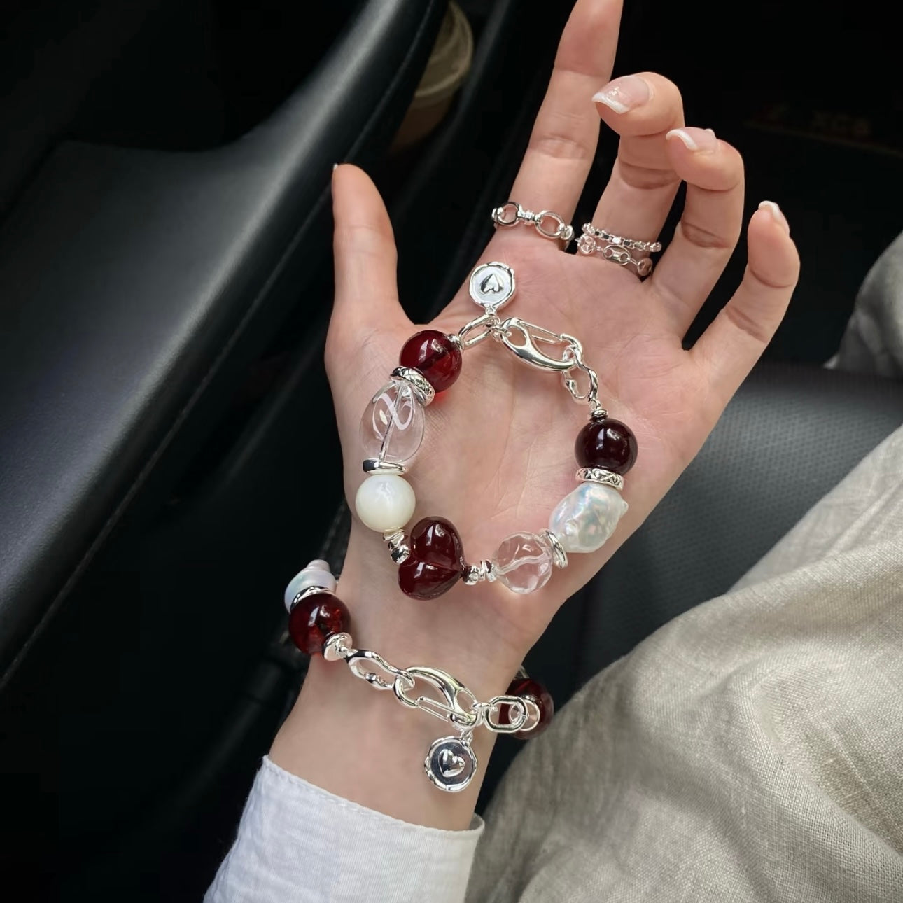 Crimson Solitude blood amber and clear crystal bracelet flat lay, gift packaging