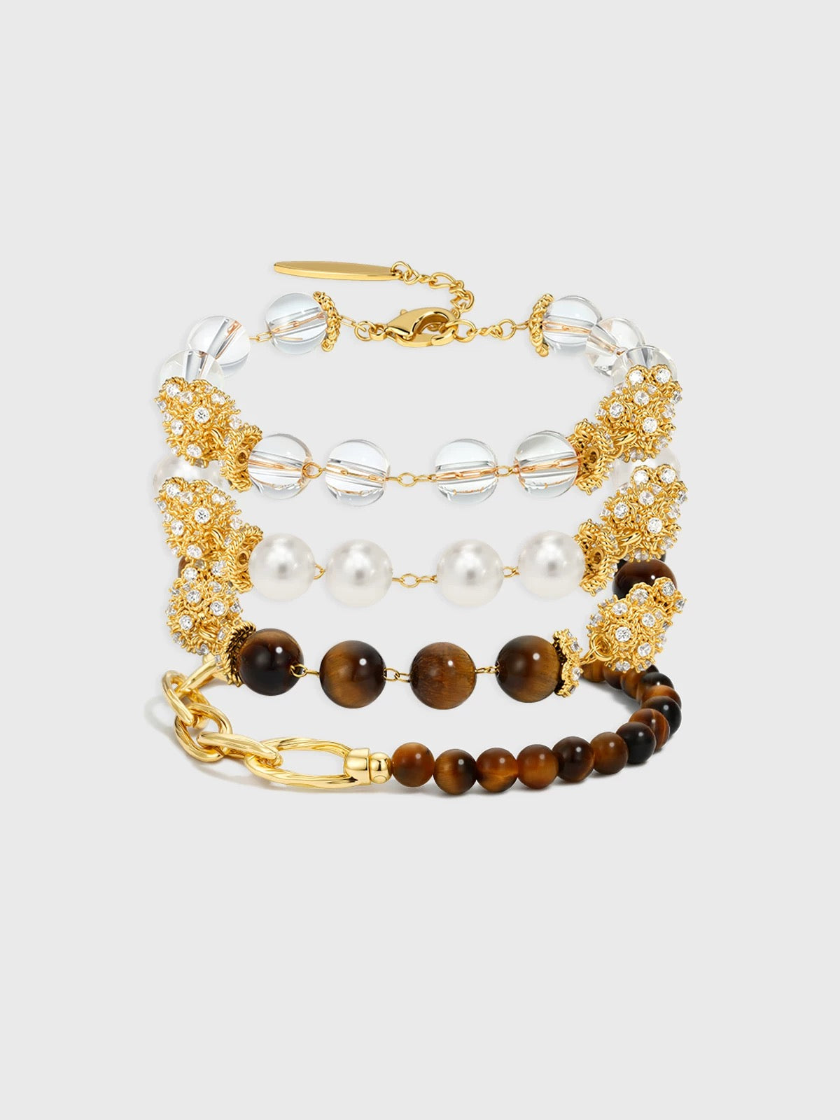 A group shot of the three-bracelet bundle showing Tiger's Eye, Pearl, and Crystal.
