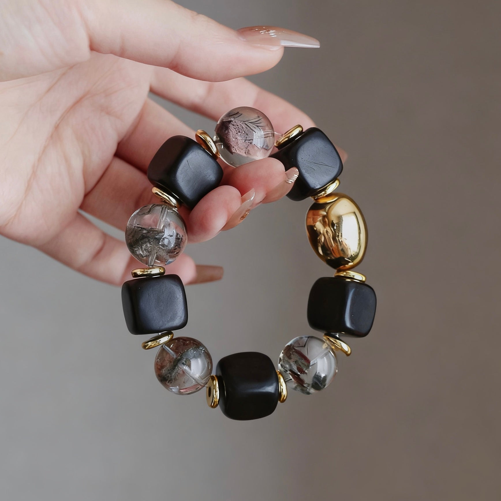 Designer ebony bracelet with a 15mm phantom crystal and 24K gold-plated accents.