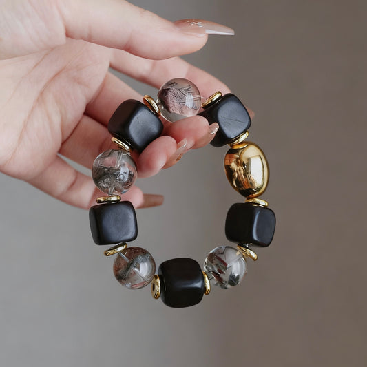 Designer ebony bracelet with a 15mm phantom crystal and 24K gold-plated accents.