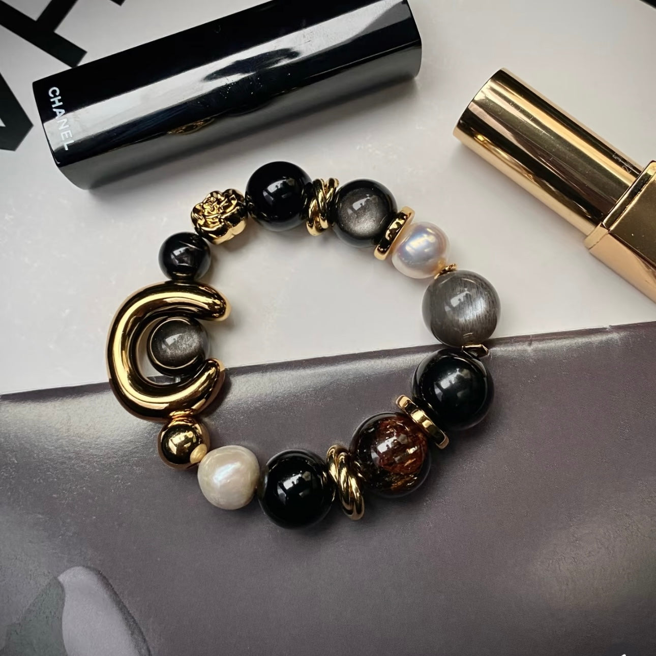 ECLIPSE multi-stone statement bracelet featuring Silver Obsidian, Black Agate and Freshwater Pearl with 24K gold titanium steel hardware