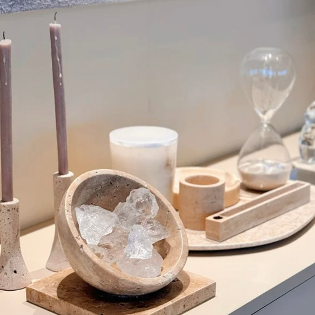 Close-up of essential oils being applied to natural Himalayan crystals for aromatherapy diffusion.