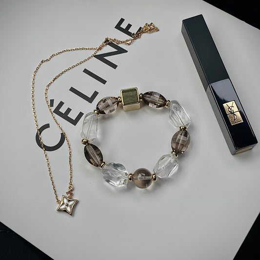 Natural Smoky Quartz and Clear Quartz bracelet featuring freeform gemstone beads styled in a minimalist flat lay for everyday wear.