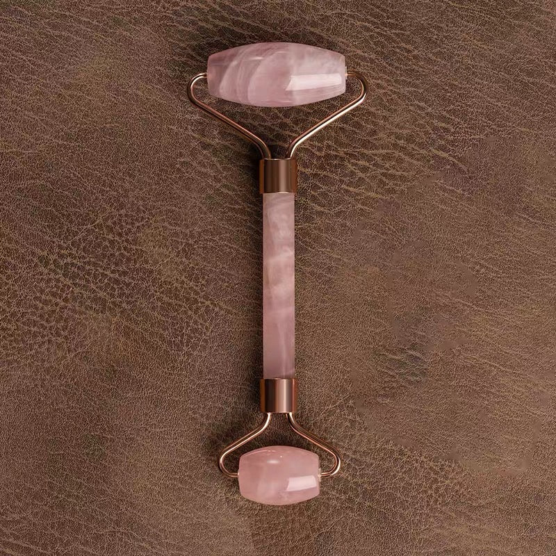 Demonstrating the use of a pink crystal gua sha for facial acupoint and multi-functional body care.