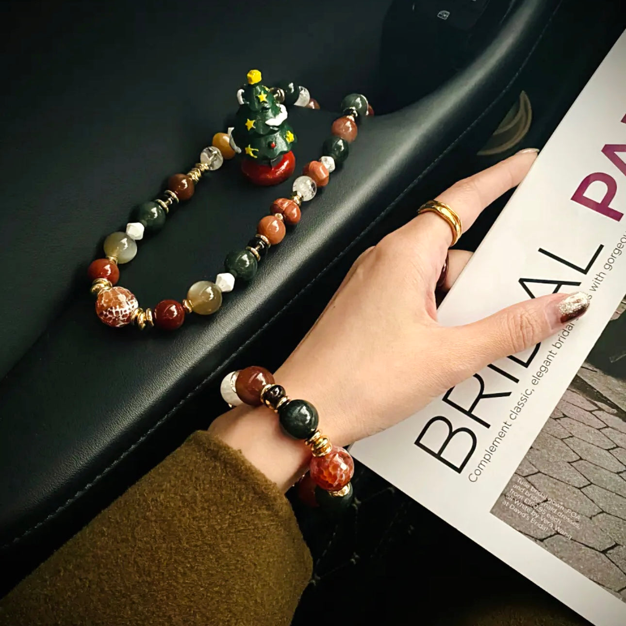 Close-up hand model with red agate and rabbit hair quartz holiday bracelet – Gentle Crystal