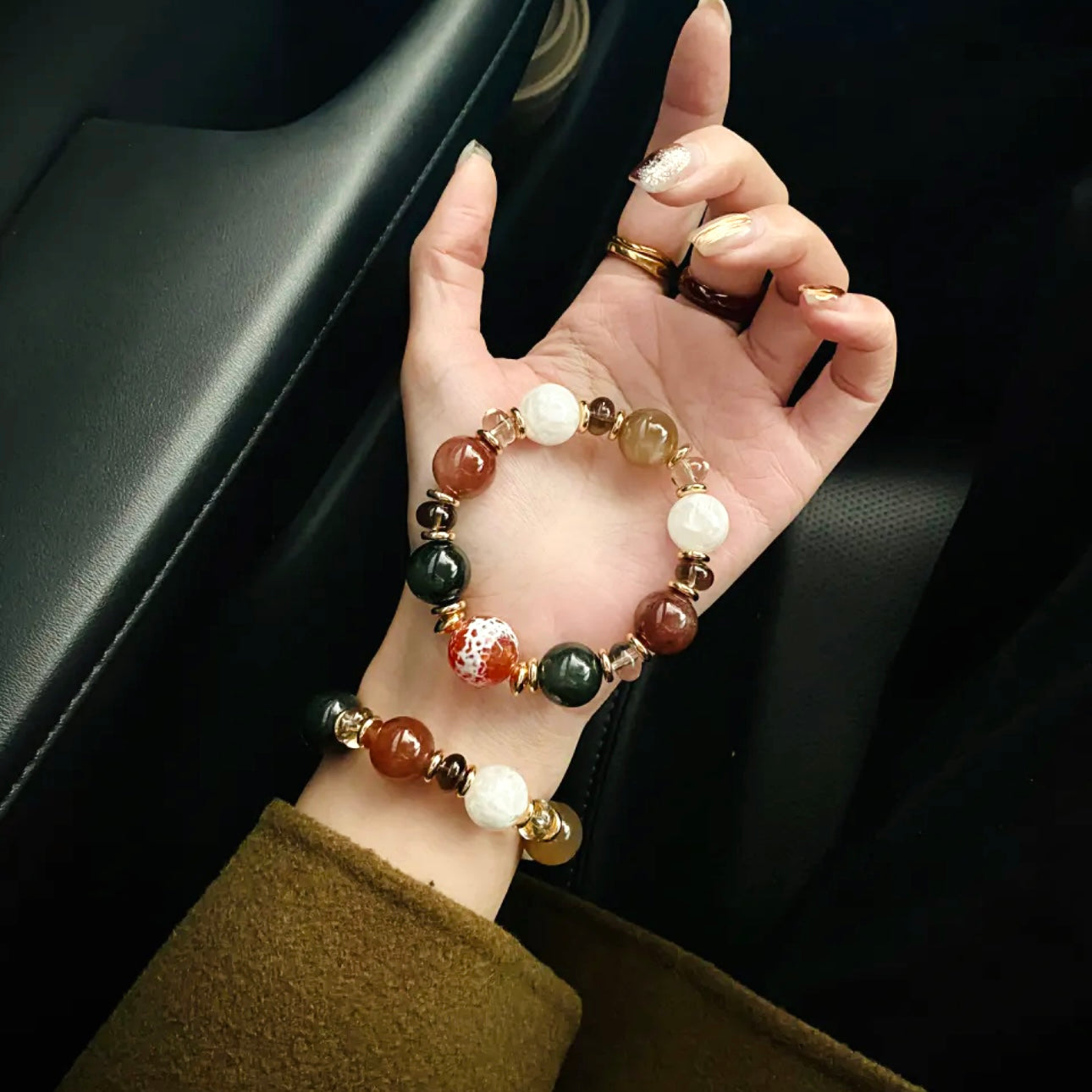 Hand model wearing red and green rutilated quartz holiday bracelet – Gentle Crystals