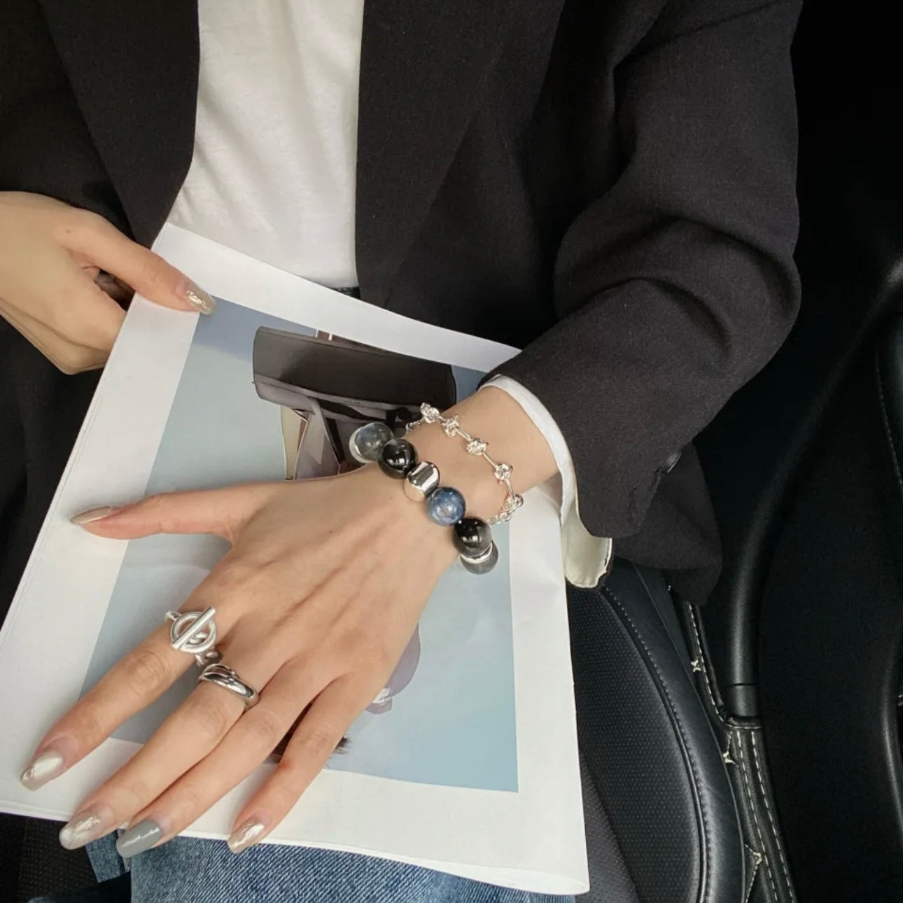 Model wearing kyanite and moonstone crystal bead bracelet with 14mm gemstone beads, close-up wrist shot