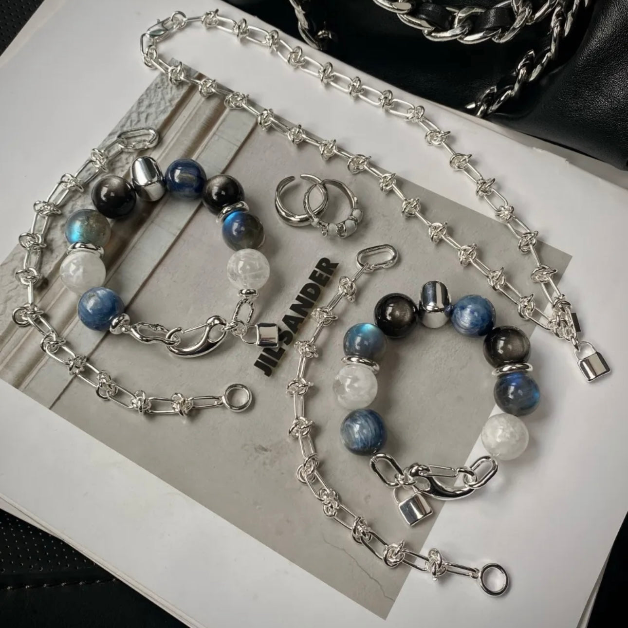 Close-up of 14mm kyanite, silver obsidian and moonstone crystal beads with precision-engraved 999 fine silver titanium steel accents