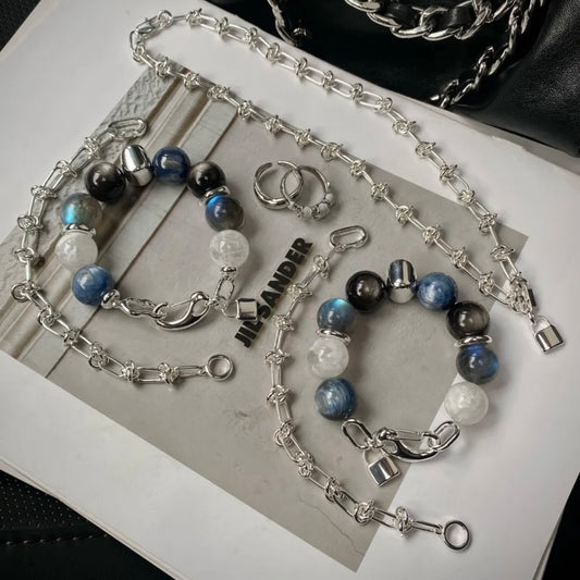 Close-up of 14mm kyanite, silver obsidian and moonstone crystal beads with precision-engraved 999 fine silver titanium steel accents