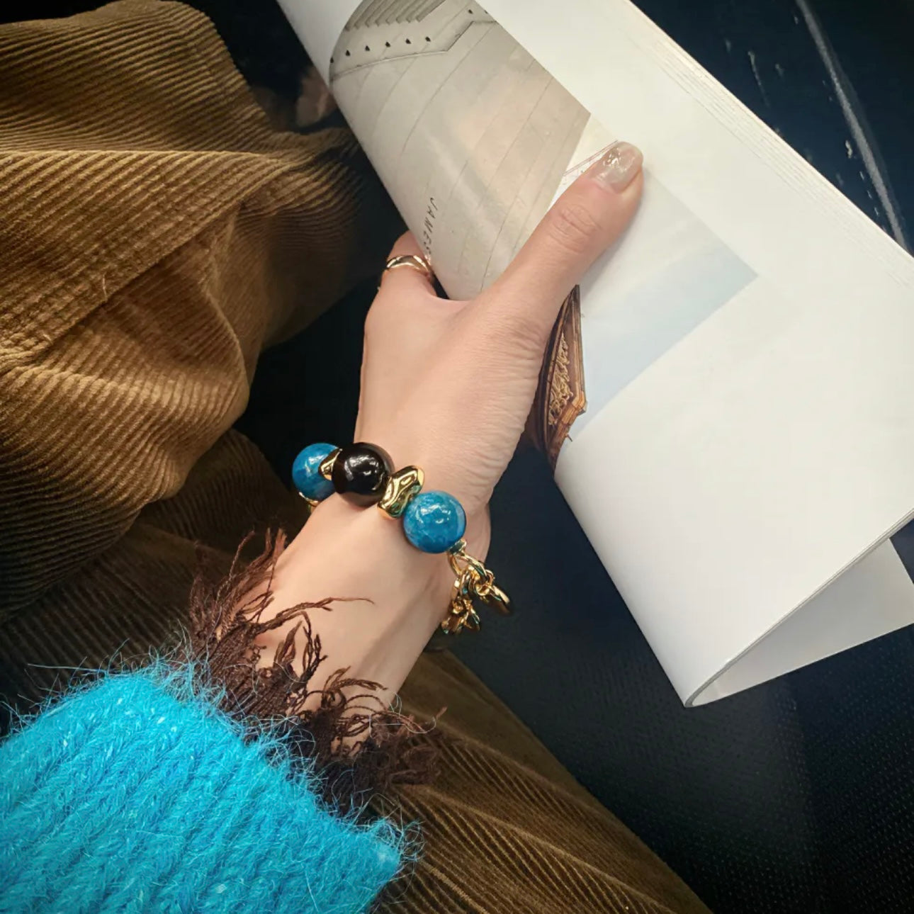 Close-up hand model with Twilight Tale blue apatite and moonstone bracelet – Gentle Crystals