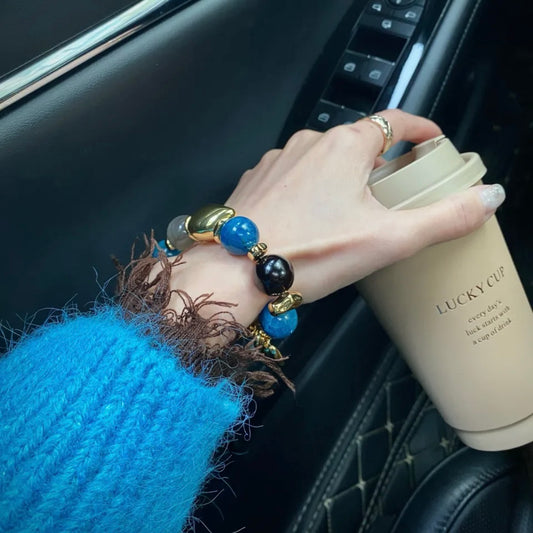 Hand model wearing Twilight Tale milk tea moonstone 14mm crystal bracelet – Gentle Crystals