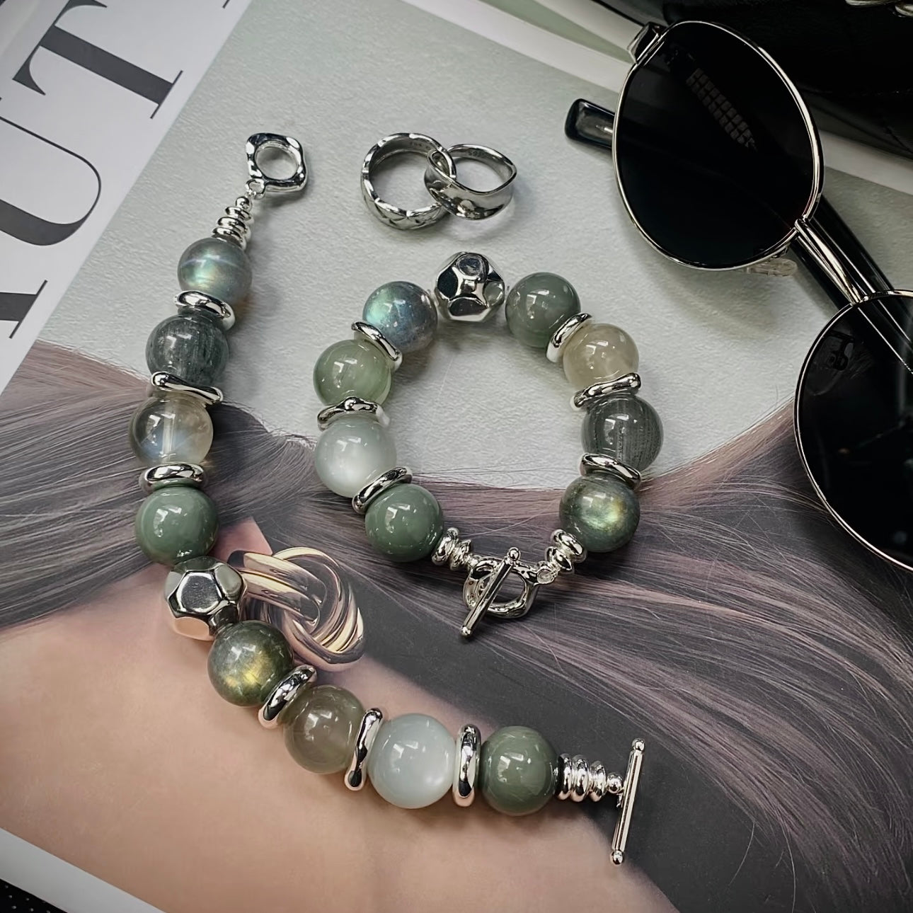 Close-up detail of Green Rutile, Grey Moonstone, and Silver Moonstone bracelet with premium silver-toned titanium steel hardware.