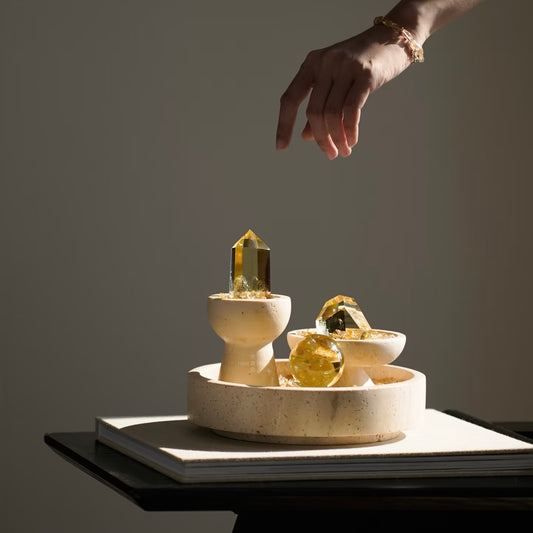 A hand holding a 5-6cm natural citrine sphere to show its warm golden luster and scale.