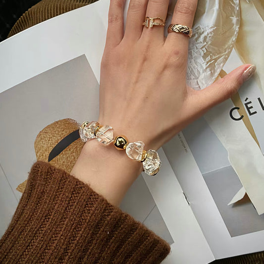Artisan 15mm freeform rock crystal bracelet with 24K gold-plated chunky chain on a model’s wrist.