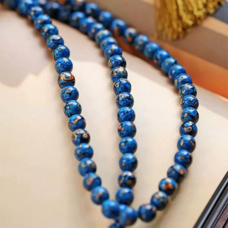 Model wearing artisan 108 mala jewelry with minimalist styling