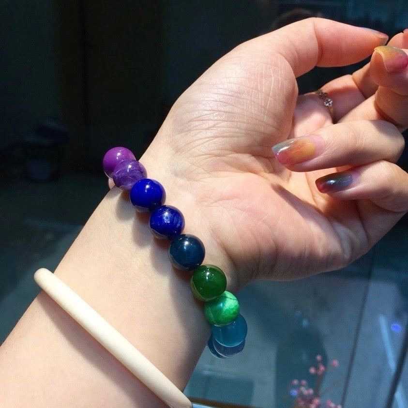 Curated 22-gemstone bracelet shown alongside raw mineral specimens for authenticity.