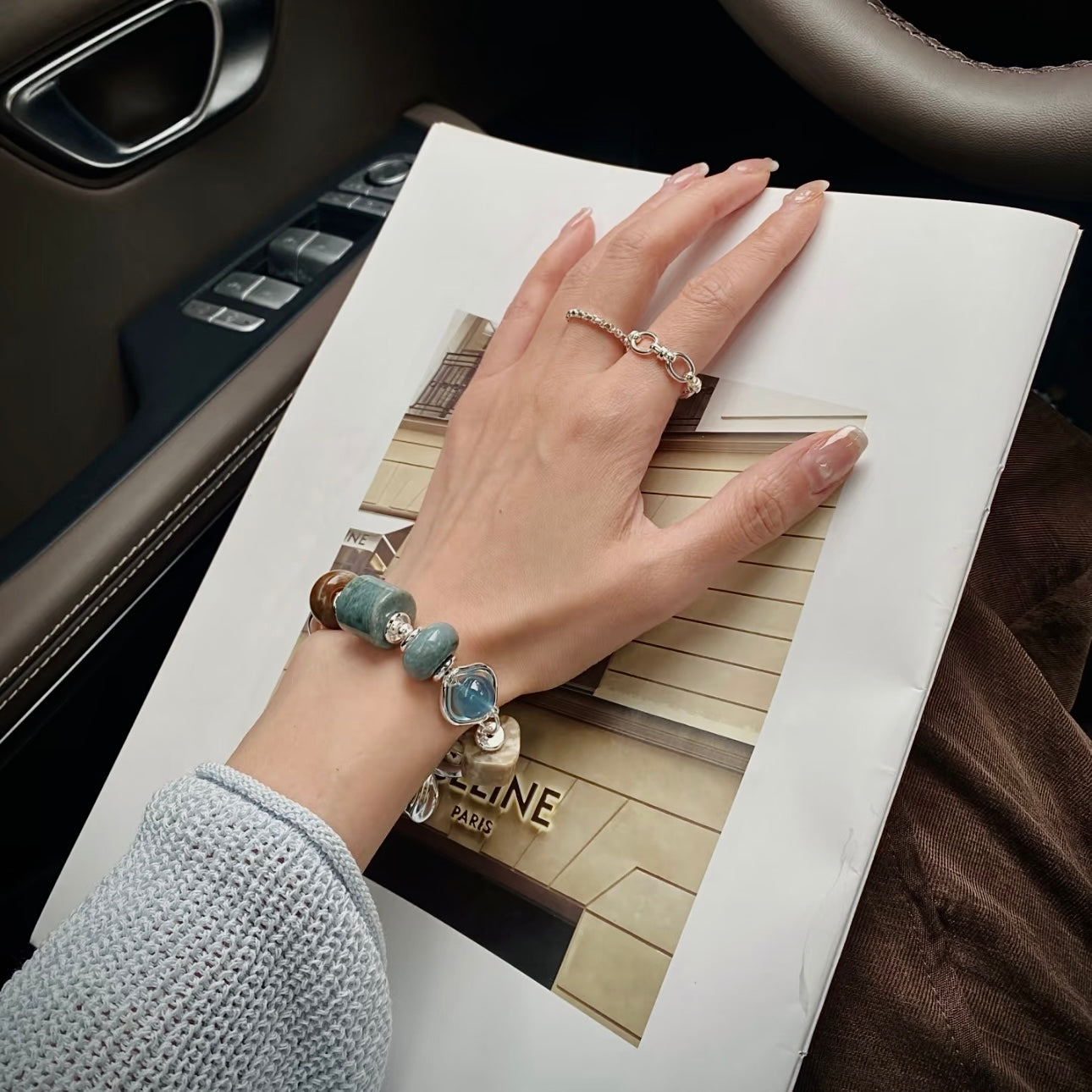 Hetian jade and devil aquamarine bracelet stacked with other natural stone bracelets — layered wrist look featuring blue skin jade, aquamarine, and black gold skeleton beads