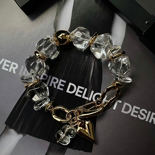 High-fashion model wearing the industrial-style crystal and gold statement bracelet.