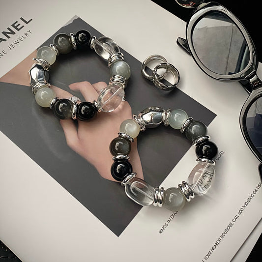 Long-termism clear quartz egg bead black agate moonstone bracelet flatlay - timeless crystal jewelry Gentle Crystals