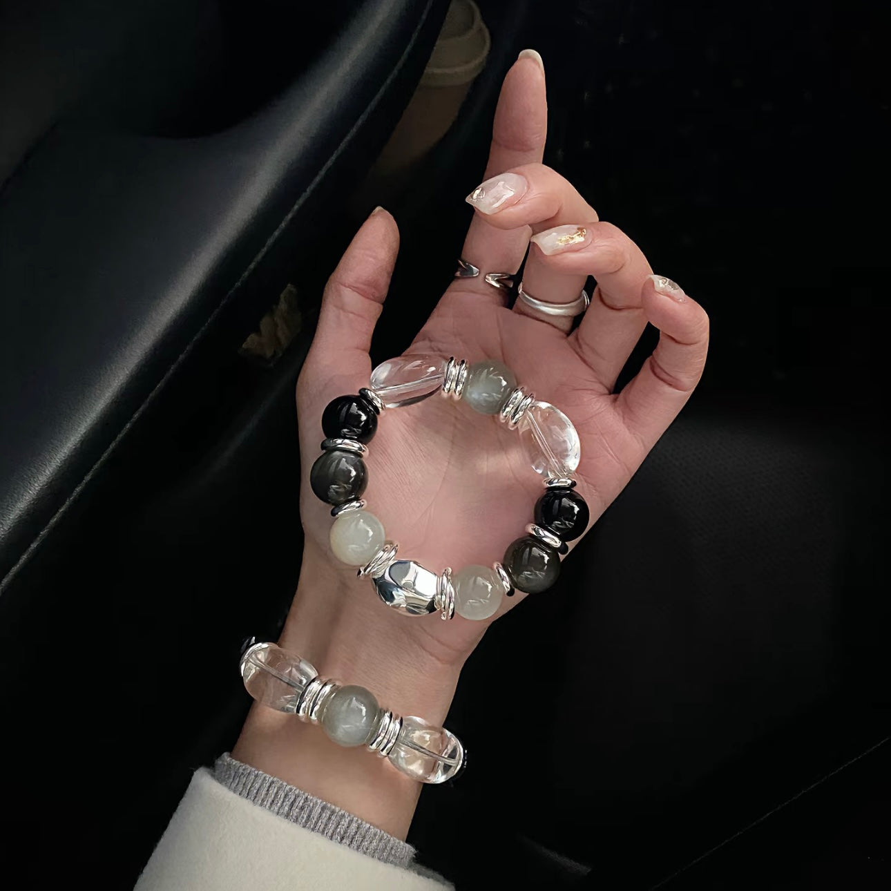 Hand model wearing Long-termism clear quartz egg bead bracelet - black agate silver moonstone Gentle Crystals