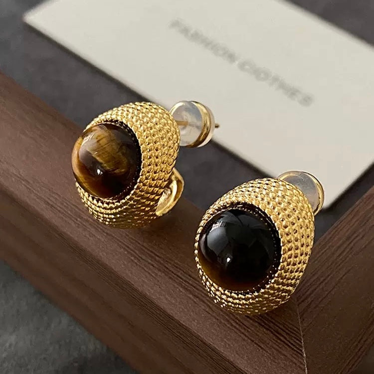 Designer Tiger's Eye earrings styled on a wooden surface, representing the timeless collection by Gentle Crystals.