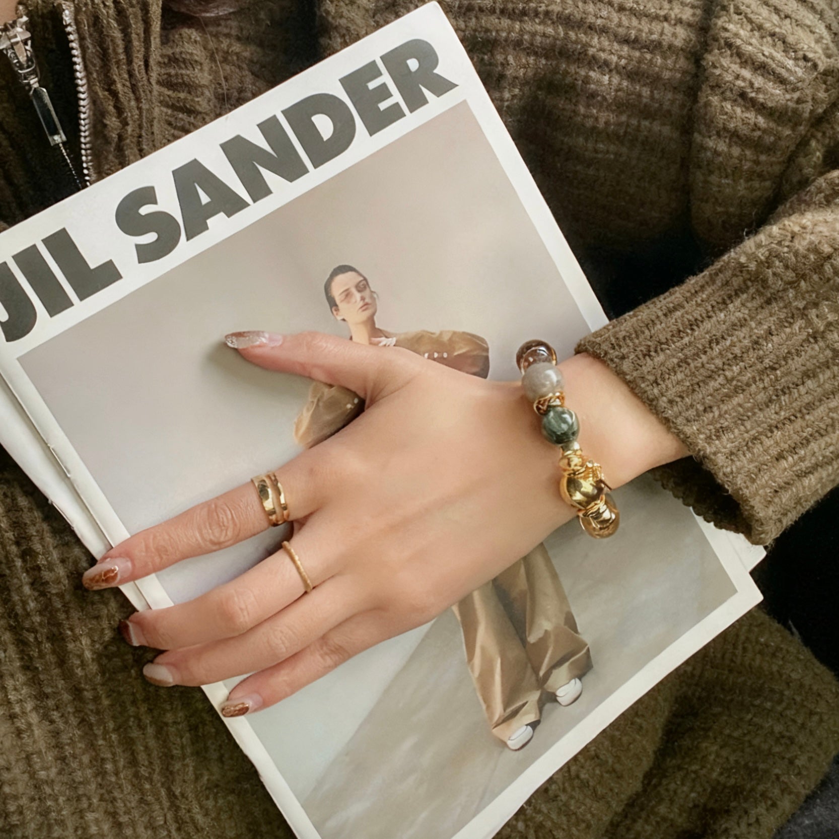 A curated flatlay featuring the high-fashion green dragon and phantom quartz bracelet.