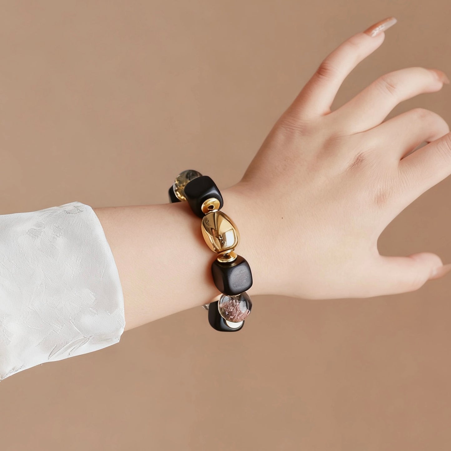 Close-up of the smooth matte ebony wood and the shiny 24K gold-plated titanium steel.
